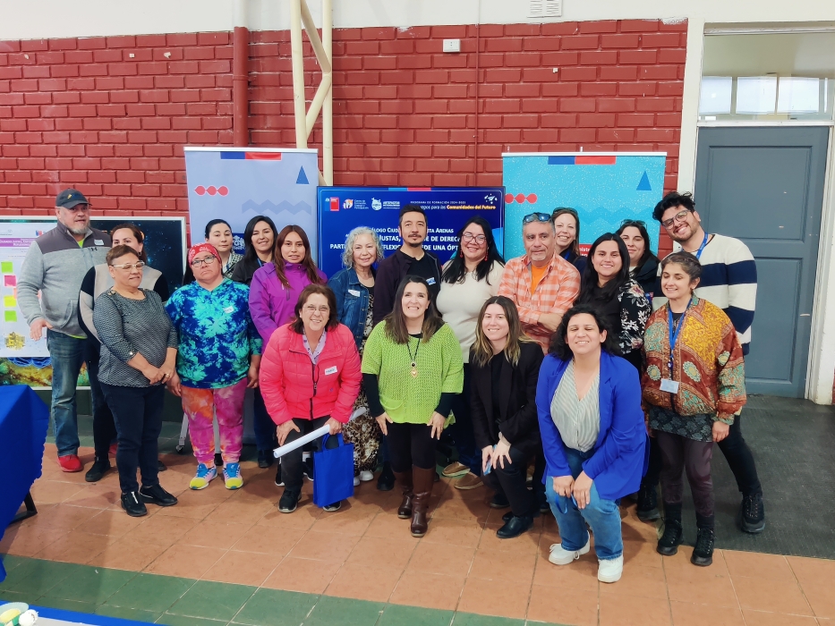 Grupo de personas posando para foto junto a pendones